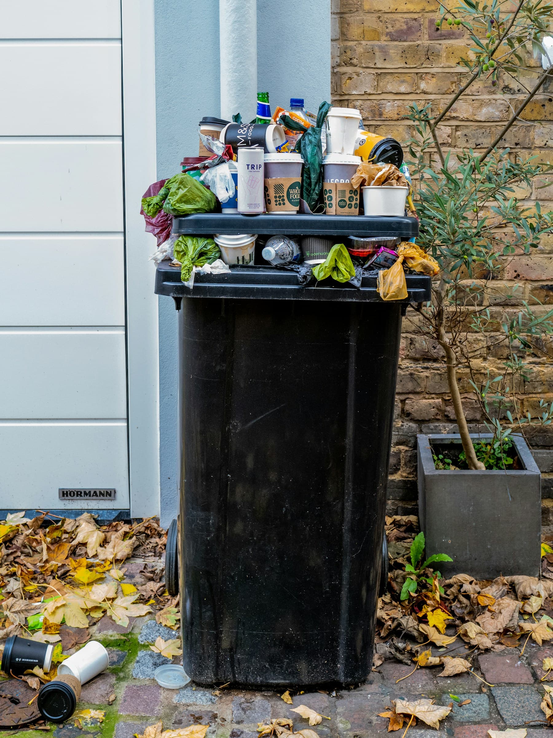Overflowing waste bin representing collection and waste-management operations